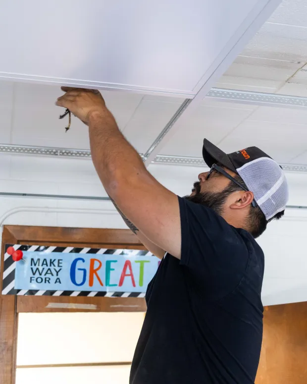 An electrician completes a lighting retrofit